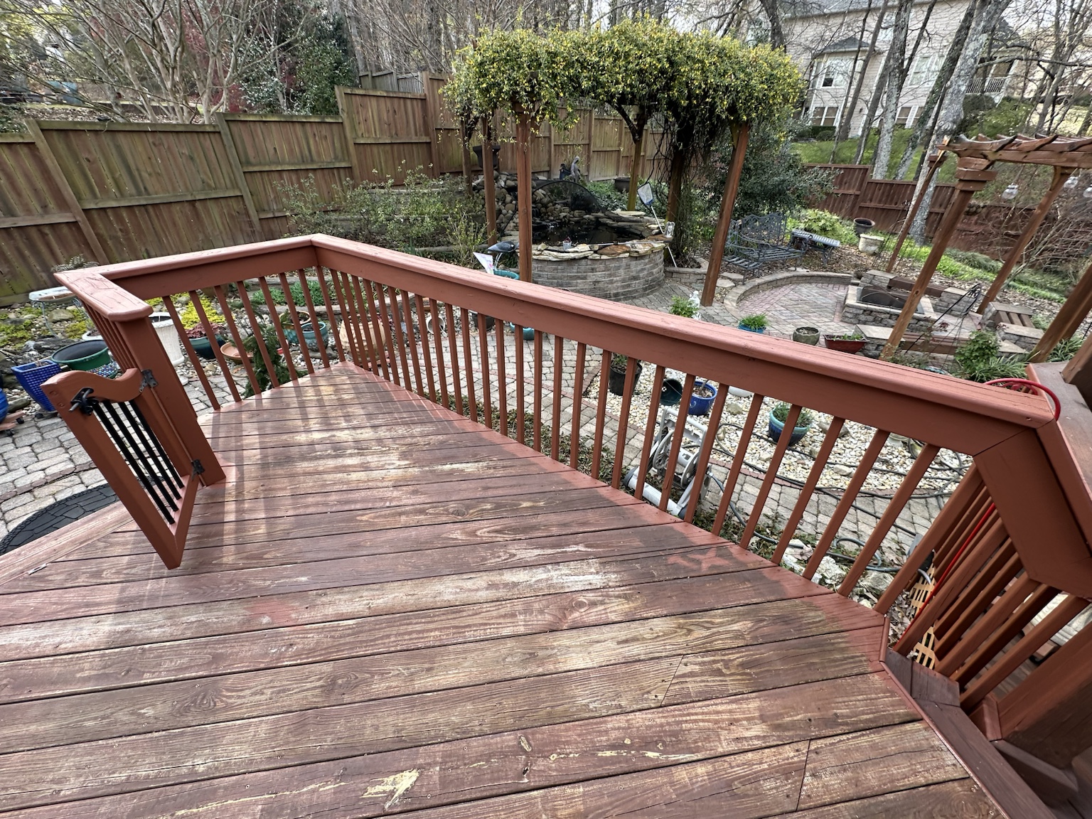 Residential deck and exterior before renovation — view 7